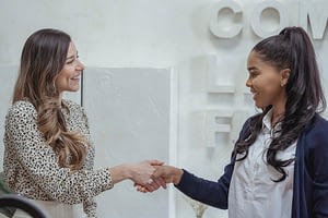 two women shaking hands